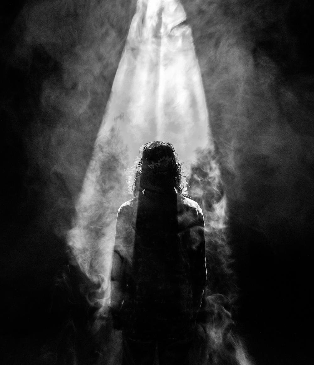Jesus standing in a smoky room.